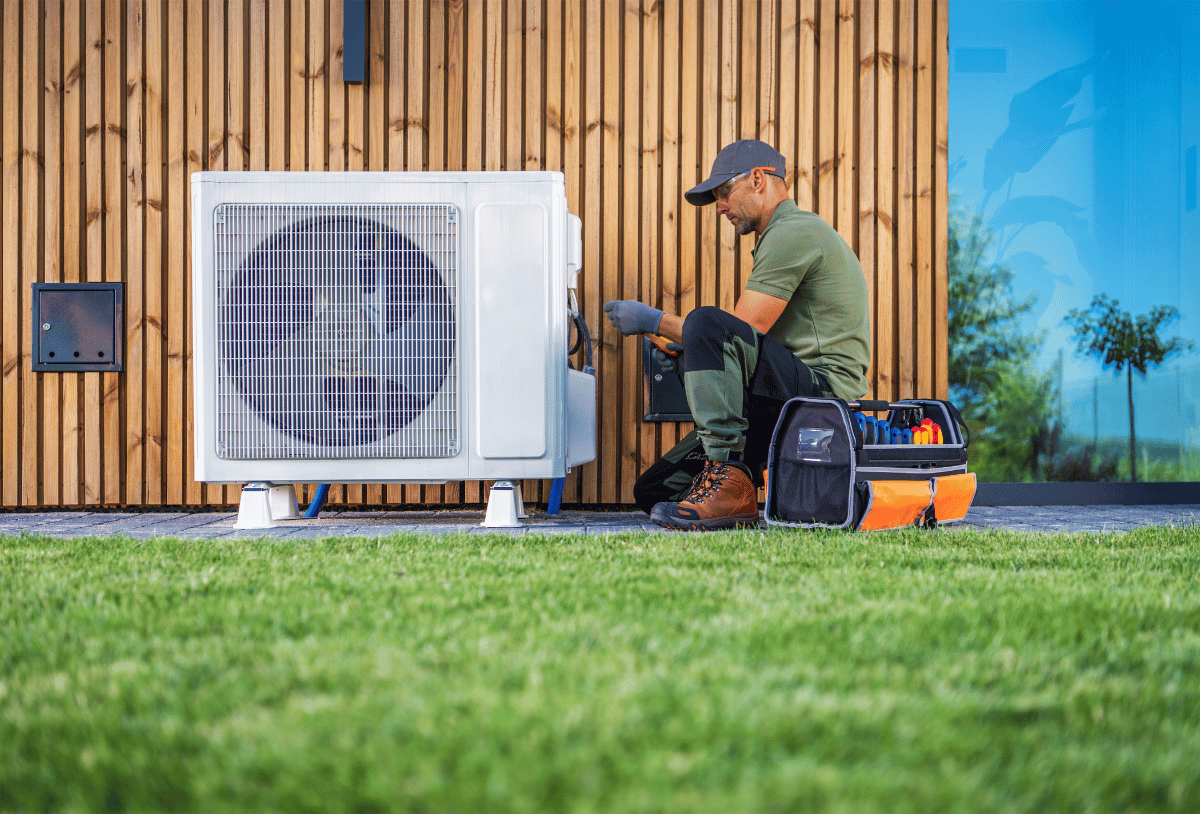 An HVAC tech installing a new AC system